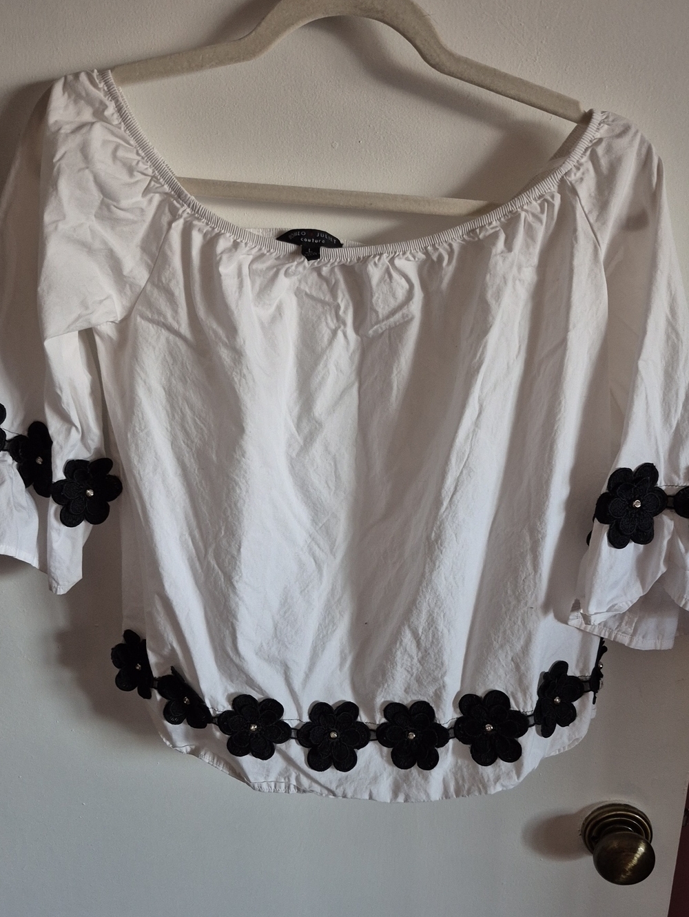 Romeo & Juliet Couture White Off-Shoulder Top with Black Floral Trim